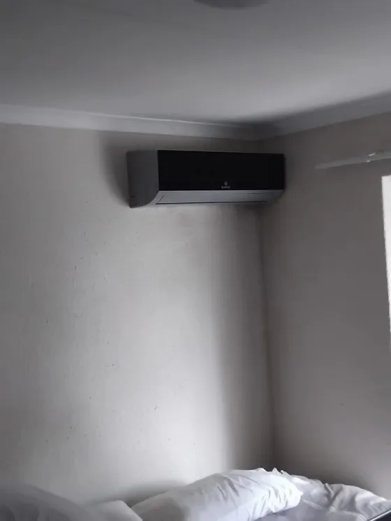 An indoor air-conditioning unit fitted beneath the ceiling cornice.