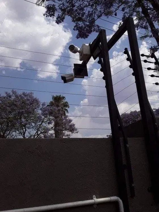 A view of the camera mounting structure and neighbouring electric-fence posts.