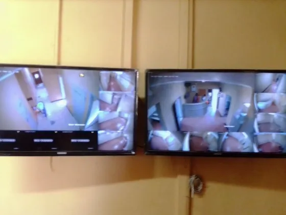 Two wall-mounted monitors displaying multiple camera views.
