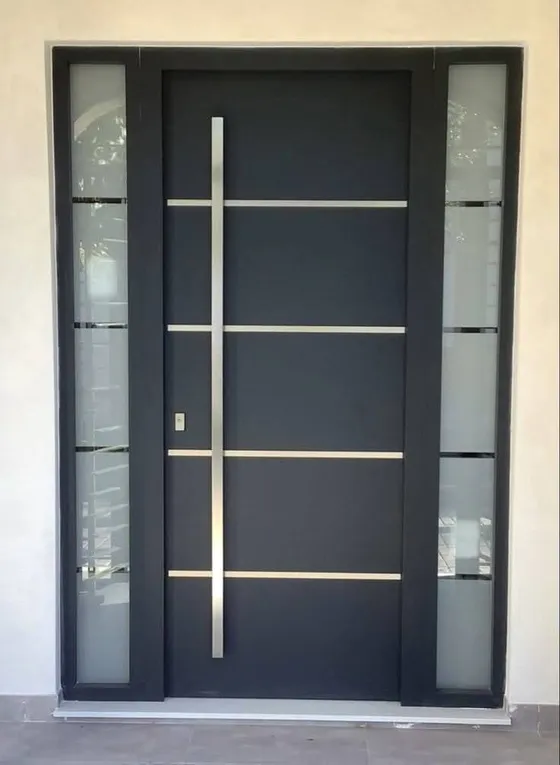 A dark entrance door with silver horizontal details, a long pull handle and glazed sidelights.