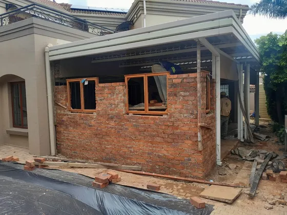 Exposed brickwork and window openings during an extension project.