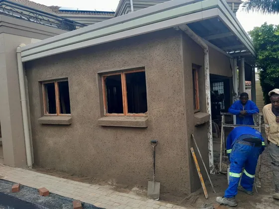 The extension takes shape as exterior plaster is applied around the windows.