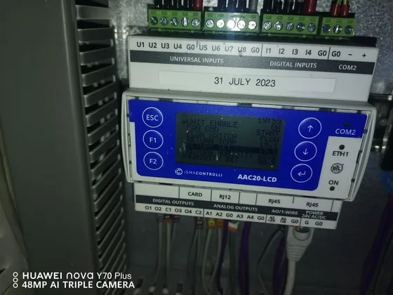 A control module and labelled wiring inside an open equipment panel.