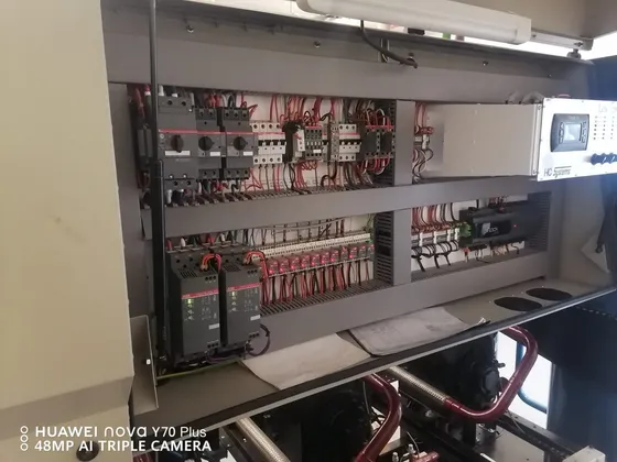 An open control cabinet showing switching components and organised wiring.