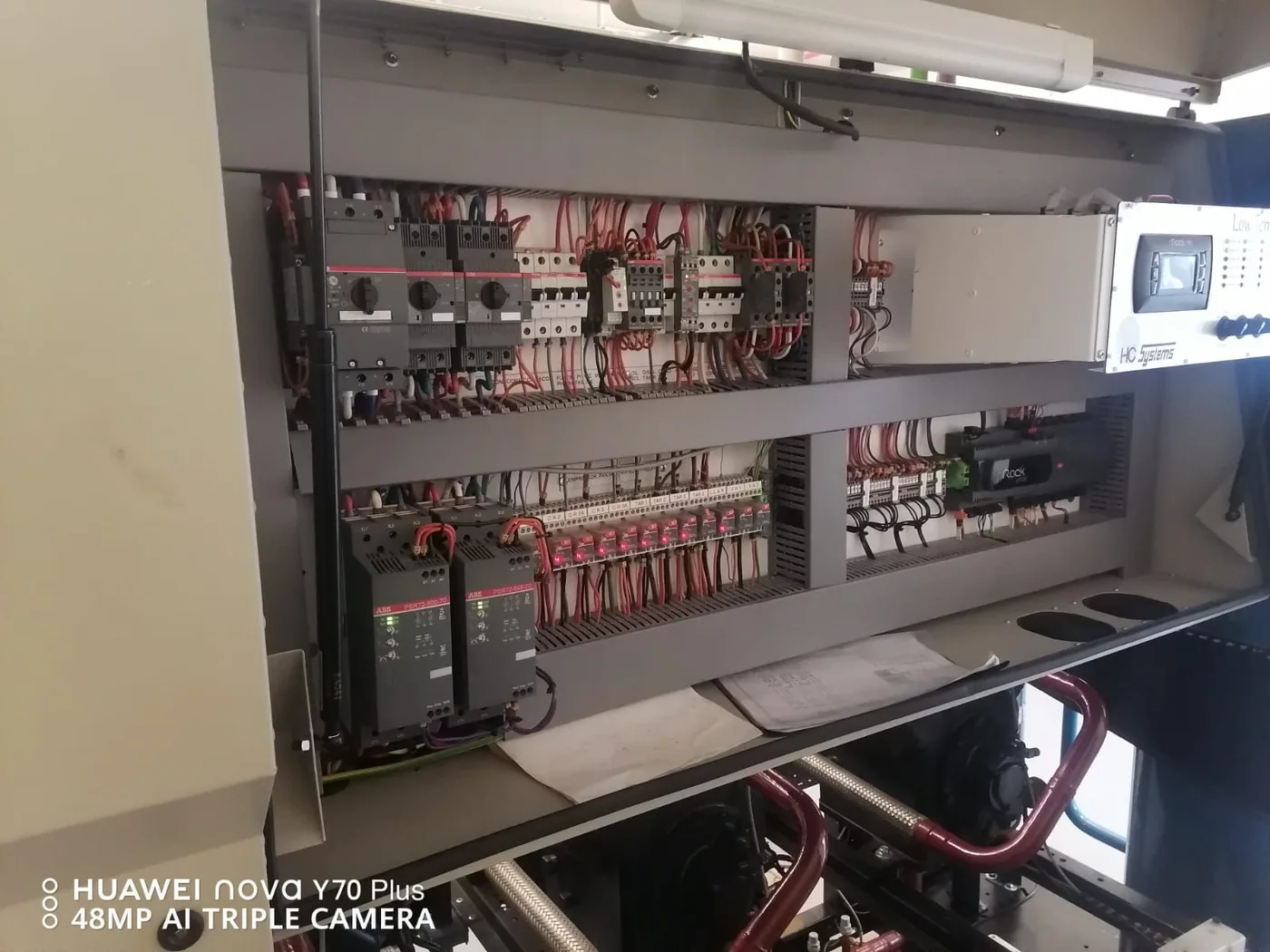 An open control cabinet showing switching components and organised wiring.