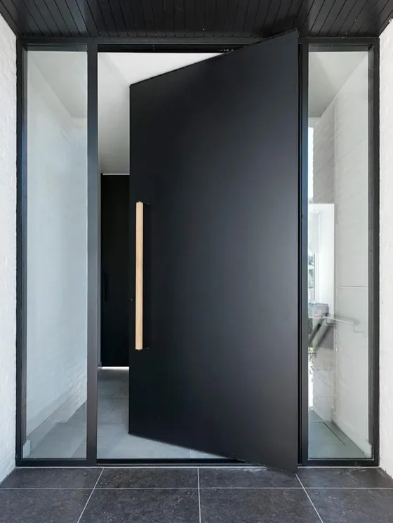 A dark entrance door with narrow glazed side panels.
