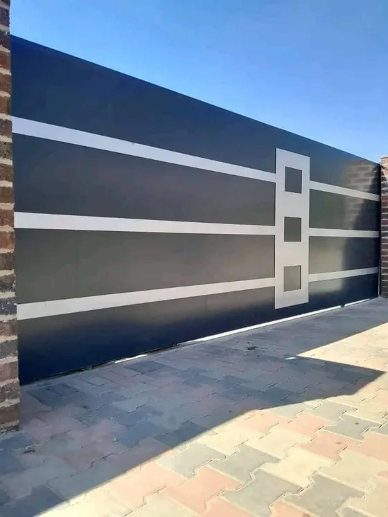 A dark property gate with contrasting horizontal and geometric details.