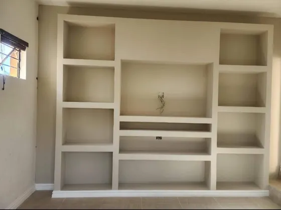 Open built-in shelves and lower drawers before finishing.